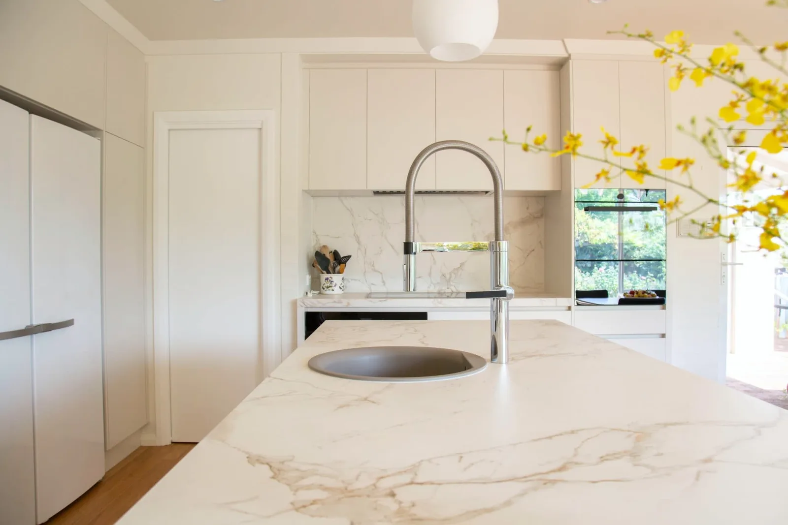 Bright luxury kitchen with marble island in a San Diego home